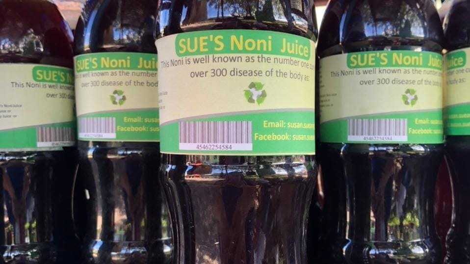 Bottles of Sue's Noni Juice with her own labels (photo from her Facebook page)